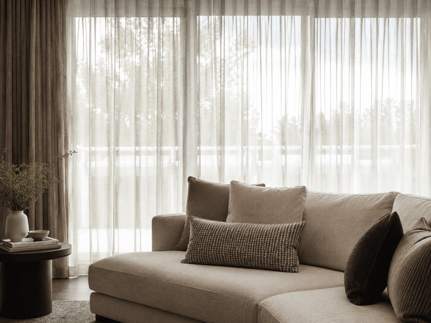Soft living area with day curtains filtering daylight
