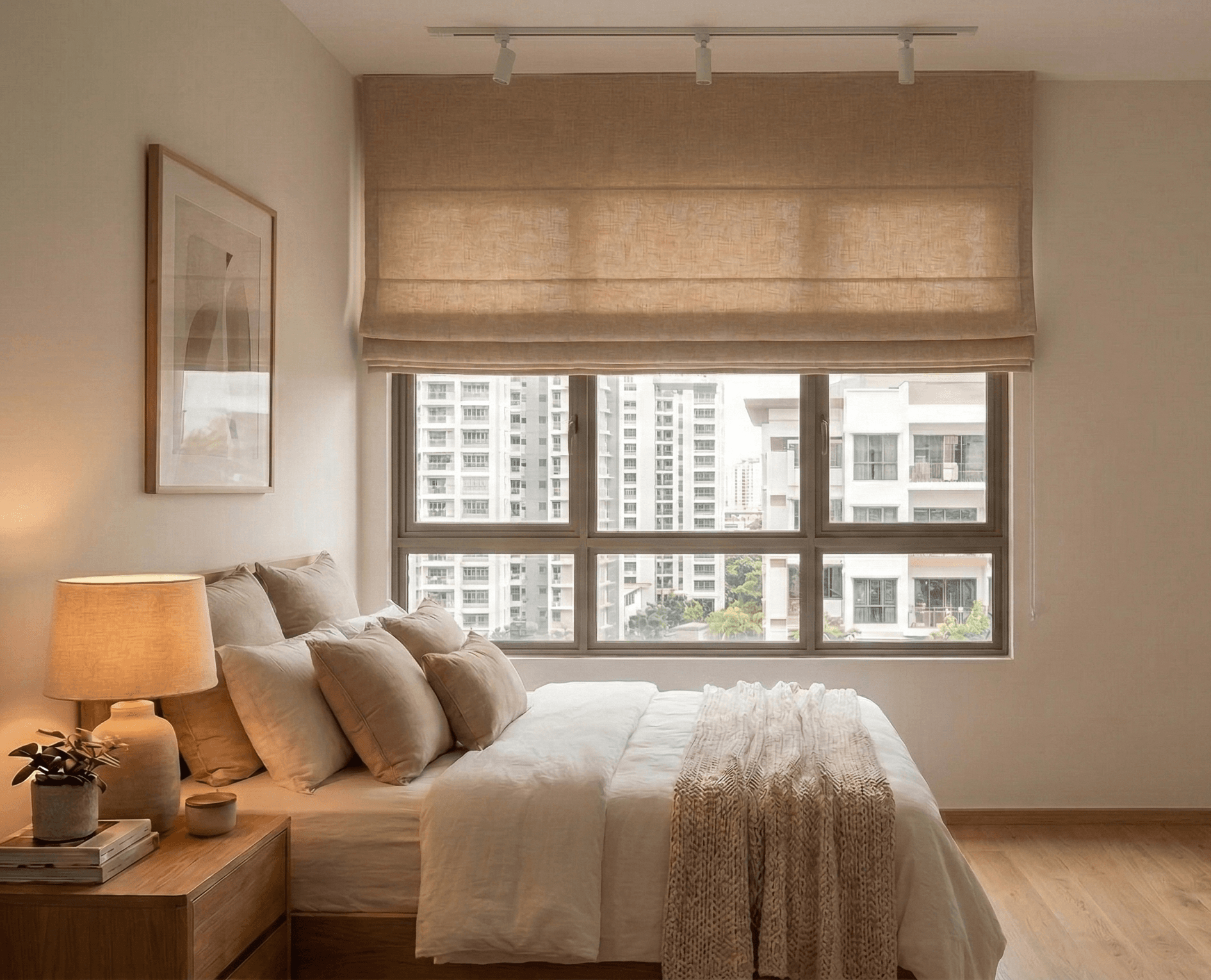 Linen roman blind with neat horizontal folds in a Singapore bedroom creating a warm, textured window treatment