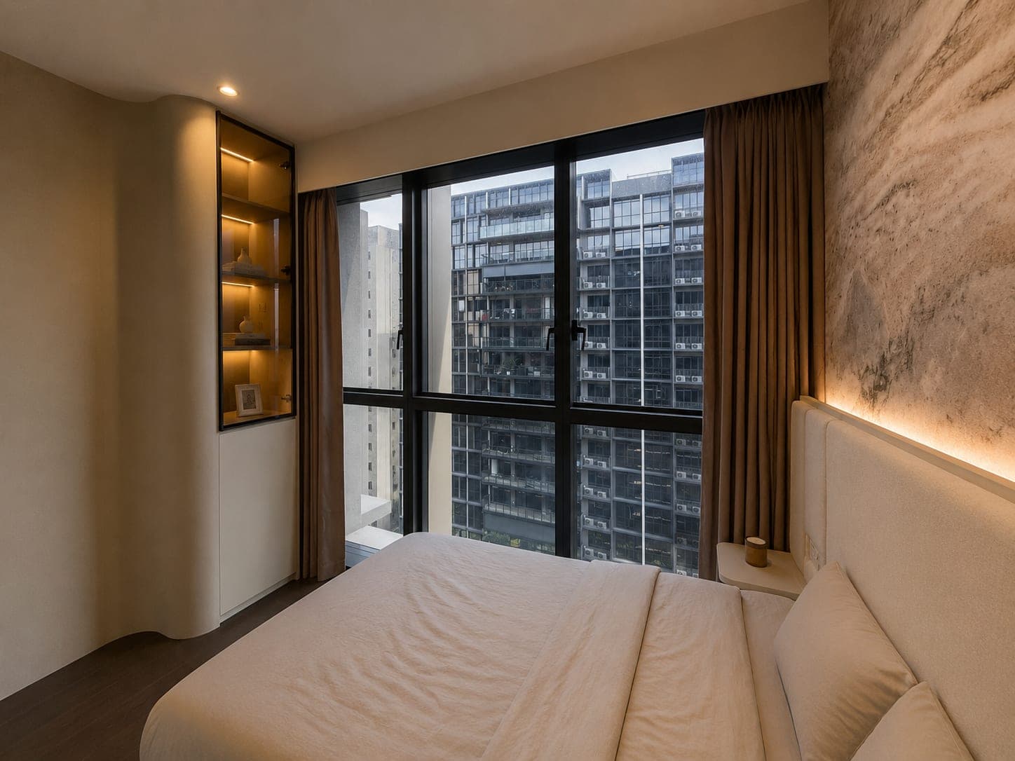 The same bedroom with the night curtains drawn open to either side, showing floor-to-ceiling sliding doors onto a balcony