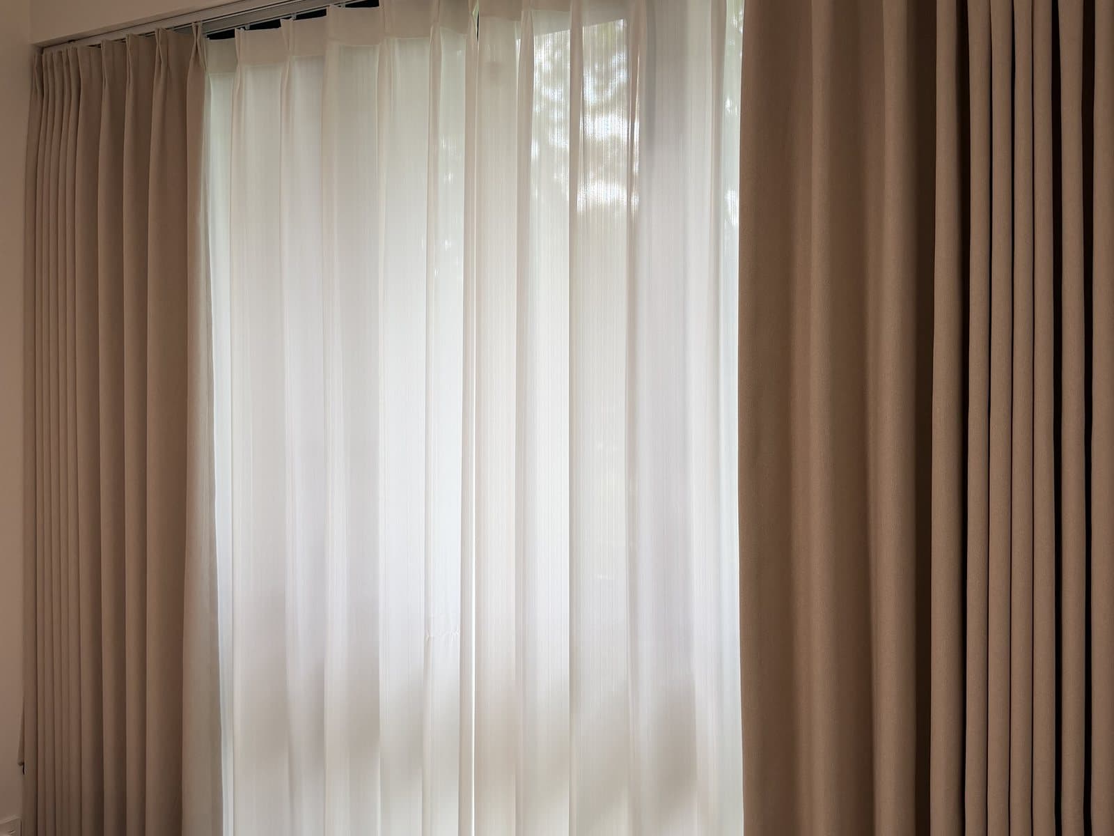 Dimout curtains reducing glare in a bedroom