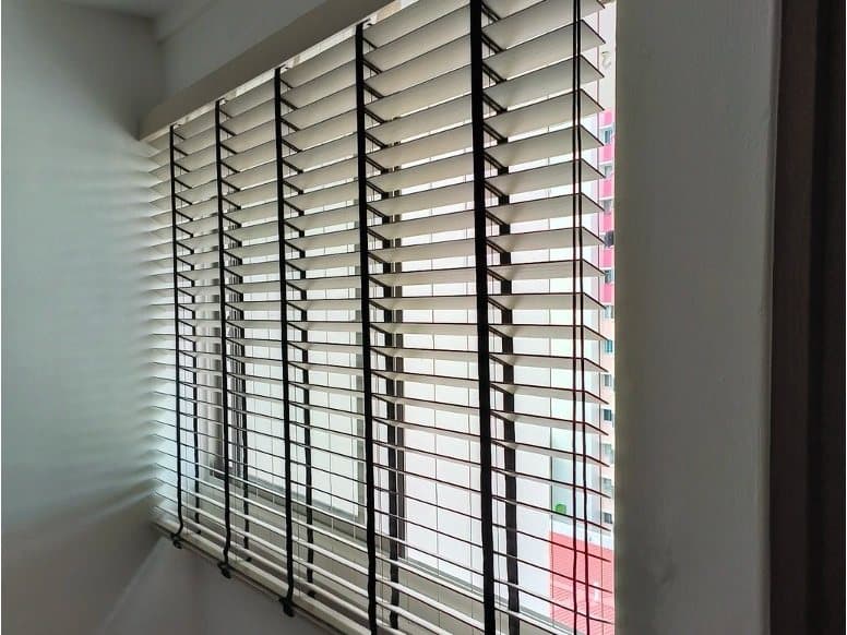 Venetian blinds fitted to a Singapore window